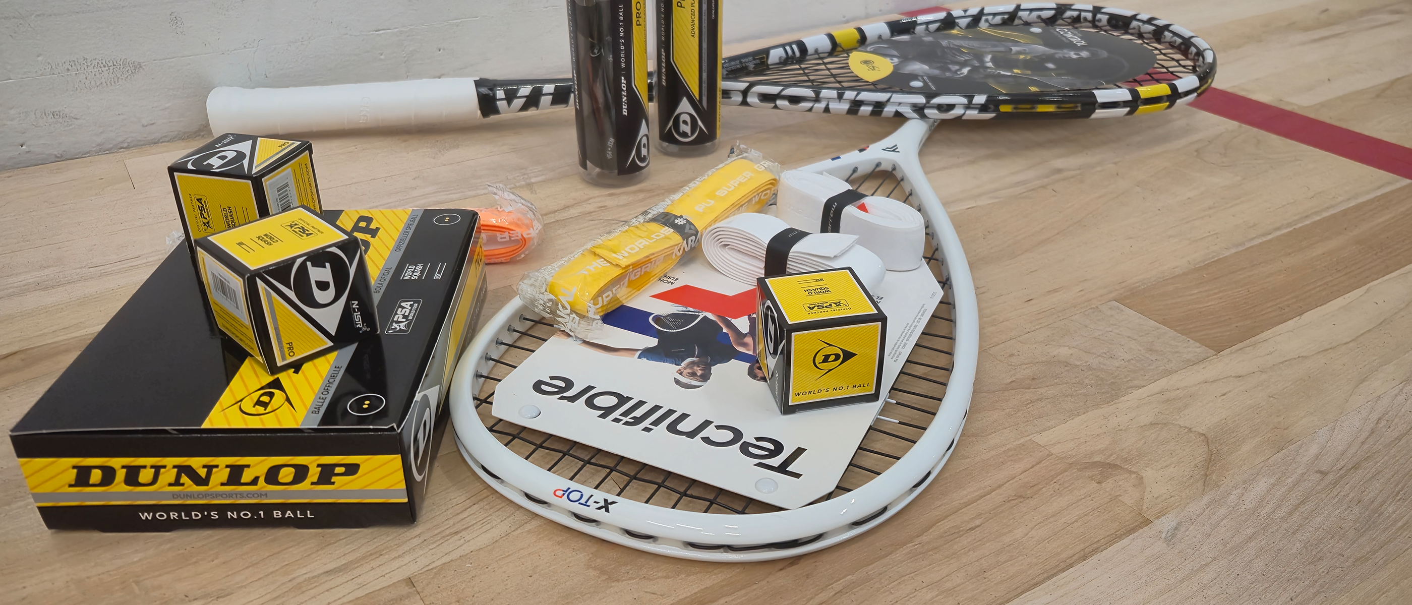 Squash equipment laying on a court. 